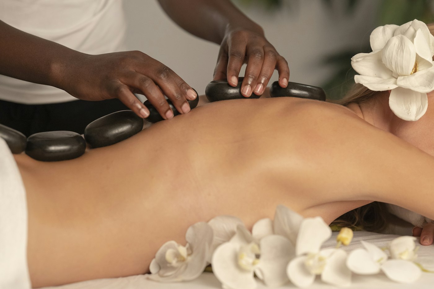 Hot stone massage with white orchids