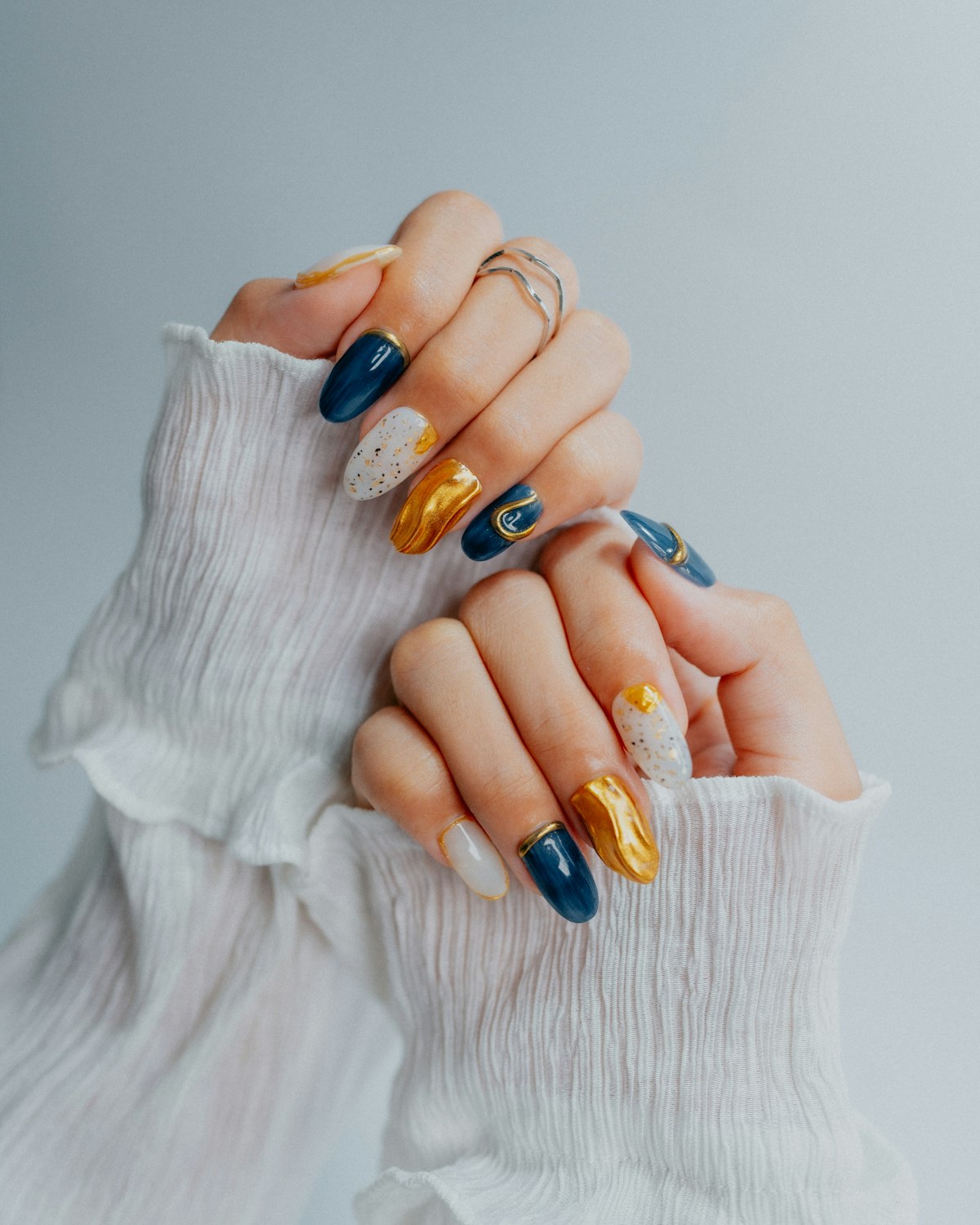 Ornate navy, gold and white nail art
